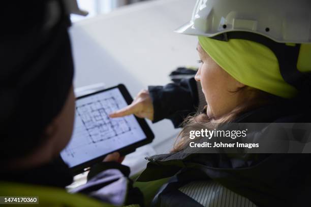 engineers checking plans on digital tablet - design engineer stock pictures, royalty-free photos & images