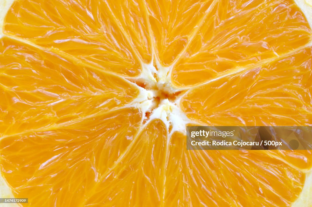 Top view of a fragment of the orange fruit slice close up Macro background texture,Romania