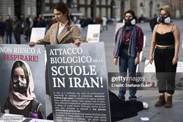 Women wear a gas mask as a reminder of the toxic gas poisoning of Iranian schoolgirls on March 17, 2023 in Turin, Italy. Demonstrators have come...