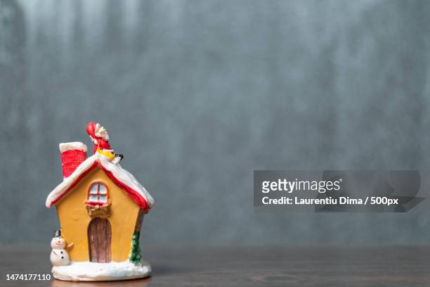 merry christmas and happy holidays cute santa claus sitting on the roof - gingerbread house cartoon stock pictures, royalty-free photos & images
