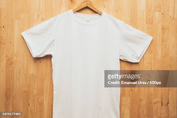 white short sleeve t-shirt plain round neck mock up concept idea wooden back ground front view,romania - t shirt stockfoto's en -beelden