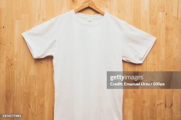 white short sleeve t-shirt plain round neck mock up concept idea wooden back ground front view,romania - editorial template stock pictures, royalty-free photos & images