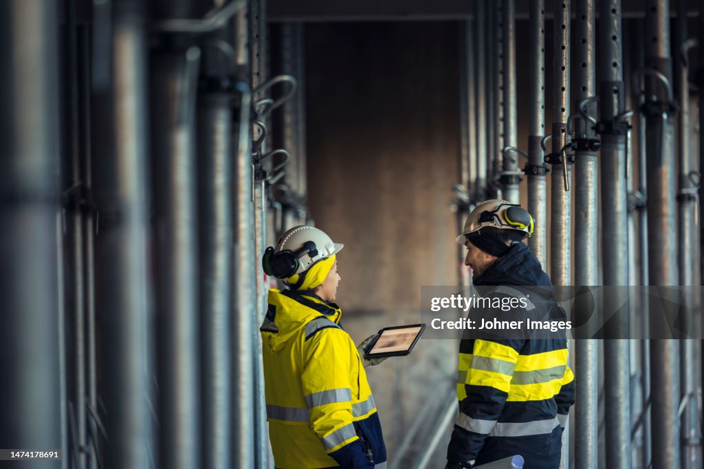Engineers talking at building site
