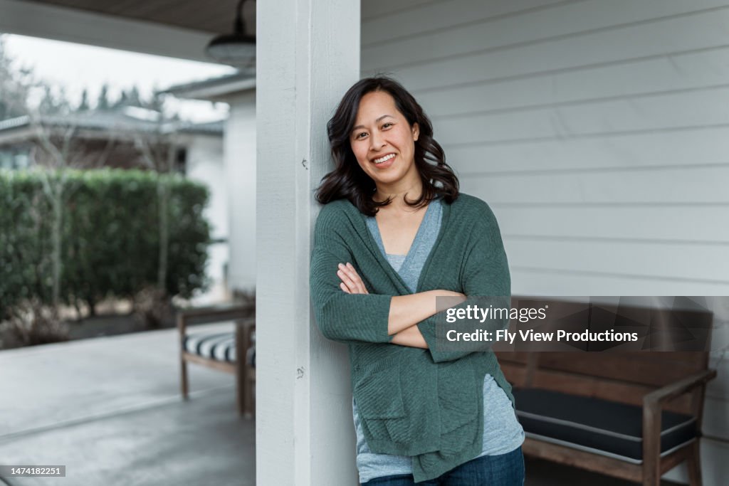 Woman on front patio of modern farmhouse style home