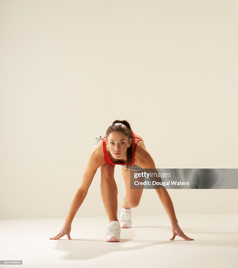 Female runner in starting position.