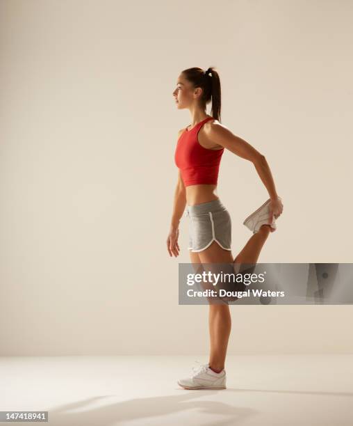 female athlete stretching. - stretching hamstring stock pictures, royalty-free photos & images