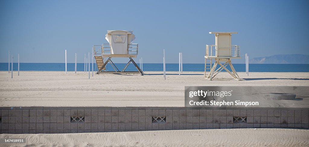 Empty beach with lifeguard towers