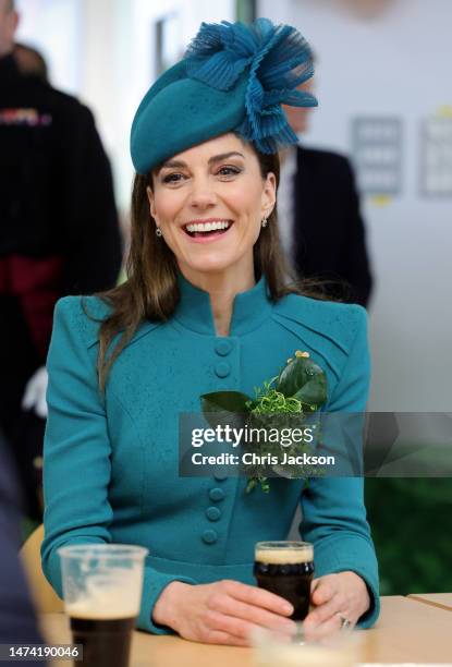 Catherine, Princess of Wales enjoys a glass of Guinness during the St. Patrick's Day Parade at Mons Barracks on March 17, 2023 in Aldershot, England....