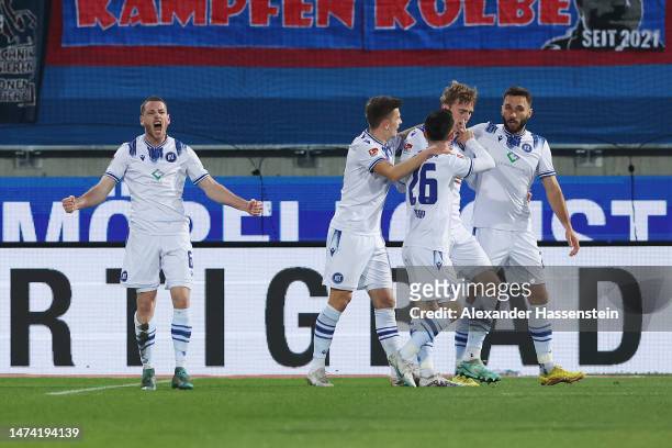 Leon Jensen of Karlsruher SC celebrates with teammates after scoring the team's first goal during the Second Bundesliga match between 1. FC...