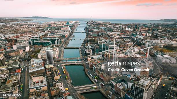 dublin ireland aerial view of river liffey and city center, aerial view of dublin skyline and samuel beckett bridge, aerial view of dublin city, ireland - aerial shots stock pictures, royalty-free photos & images