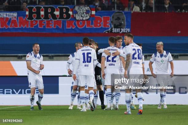 Leon Jensen of Karlsruher SC celebrates with teammates after scoring the team's first goal during the Second Bundesliga match between 1. FC...