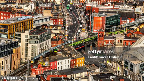 aerial view of green dart train in dublin ireland, aerial view of crowded city life, european city centre, european cityscape, aerial crowded cityscape - dublin city skyline stockfoto's en -beelden