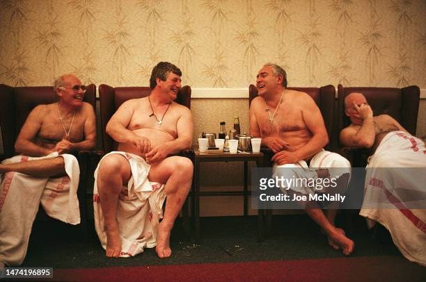Construction workers enjoying some time to talk after a steam bath at "East Ham Baths", at the end of a work day, in the Docklands in 1991, London,...