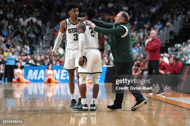 Head coach Tom Izzo of the Michigan State Spartans hugs Tyson Walker and Jaden Akins against the USC Trojans during the second half in the first...