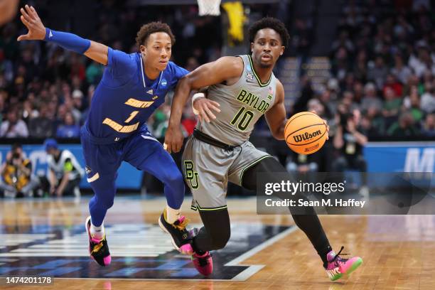 Adam Flagler of the Baylor Bears drives against Josh Pierre-Louis of the UC Santa Barbara Gauchos during the second half in the first round of the...