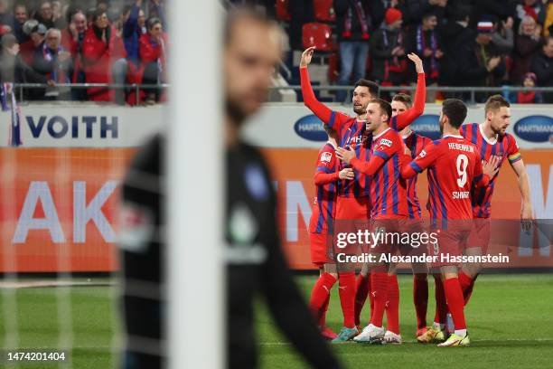 Tim Kleindienst of 1. FC Heidenheim 1846 celebrates with teammates after scoring the team's third goal during the Second Bundesliga match between 1....