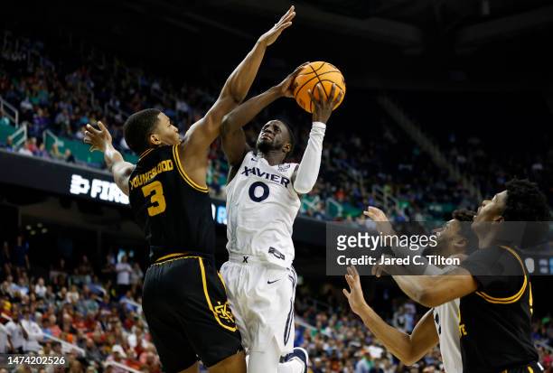 Souley Boum of the Xavier Musketeers drives to the basket as Chris Youngblood of the Kennesaw State Owls defends during the second half in the first...