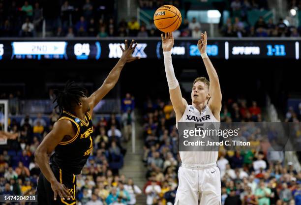 Adam Kunkel of the Xavier Musketeers shoots a three point basket against the Kennesaw State Owls during the second half in the first round of the...