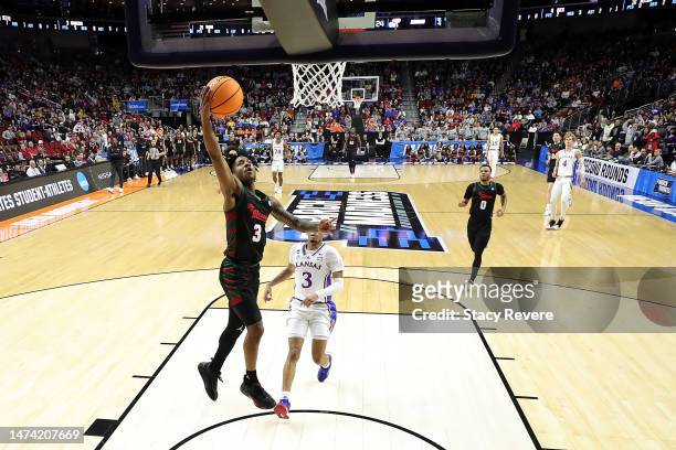 Elijah Hawkins of the Howard Bison drives to the basket against Dajuan Harris Jr. #3 of the Kansas Jayhawks in the first round of the NCAA Men's...