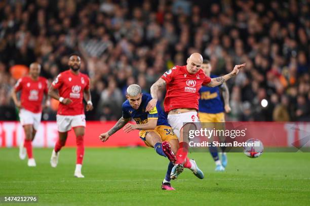 Bruno Guimaraes of Newcastle United is challenged by Jonjo Shelvey of Nottingham Forest during the Premier League match between Nottingham Forest and...