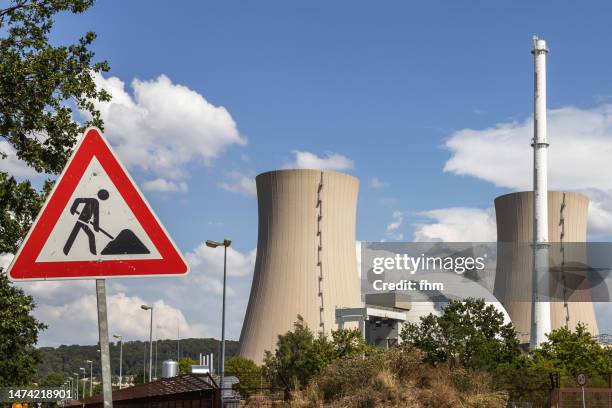 road sign "construction site" with nuclear power station - health and safety icons stock pictures, royalty-free photos & images