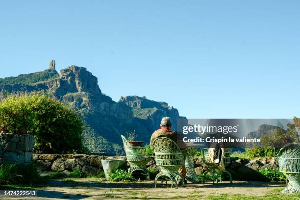 mature man having breakfast in the garden in the canary islands - distinguished gentlemen with white hair stock pictures, royalty-free photos & images