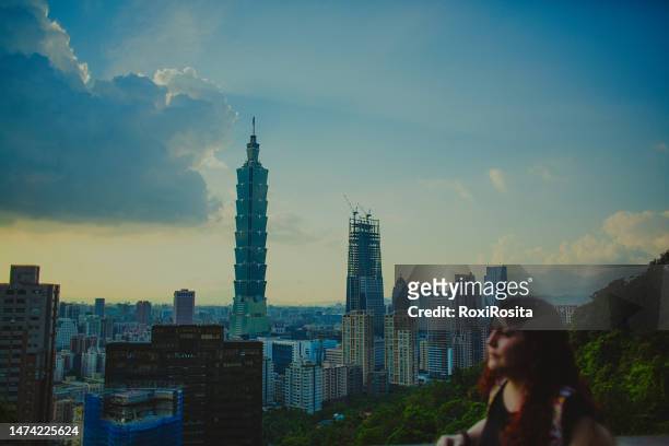 encountering grandeur: a traveler delights in taipei's impressive cityscape from above - taipei business stock pictures, royalty-free photos & images