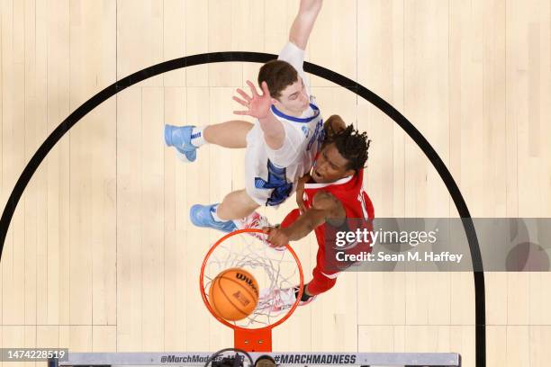 Terquavion Smith of the North Carolina State Wolfpack dunks over Ryan Kalkbrenner of the Creighton Bluejays during the second half in the first round...