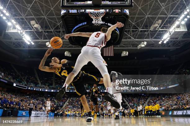 Greg Elliott of the Pittsburgh Panthers shoots the ball against Aljaz Kunc of the Iowa State Cyclones during the first half in the first round of the...