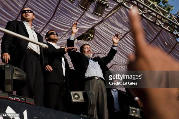 Egyptian President-elect Mohamed Morsi arrives on stage in Tahrir Square on June 29, 2012 in Cairo, Egypt. Accompanied by Egypt's 'Presidential...