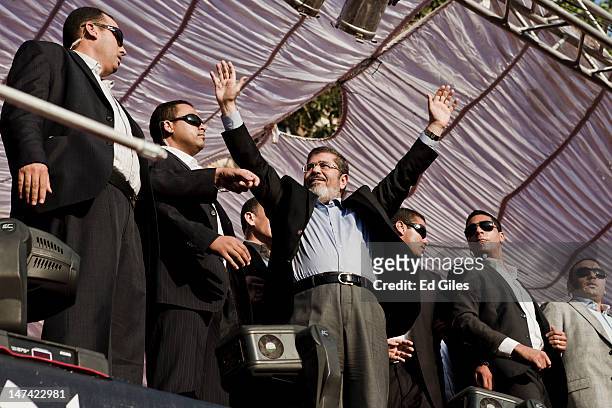 Egyptian President-elect Mohamed Morsi arrives on stage in Tahrir Square on June 29 in Cairo, Egypt. Accompanied by Egypt's 'Presidential Guard',...