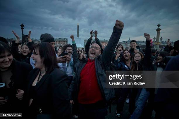 Protesters chant at Place de la Concorde as demonstrations continue for a second straight night against the French Government's pension reform on...