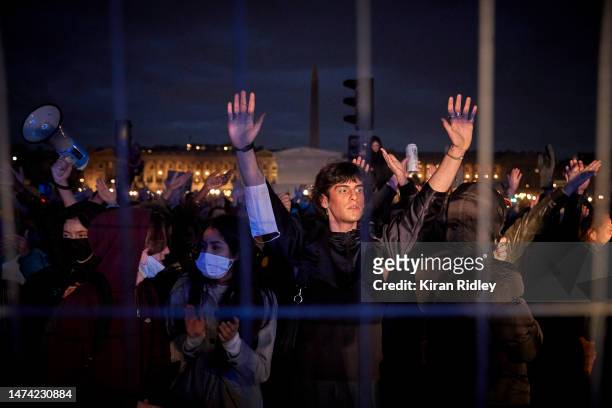 Protesters stand behind a barricade facing French Riot Police at Place de la Concorde as demonstrations continue for a second straight night against...