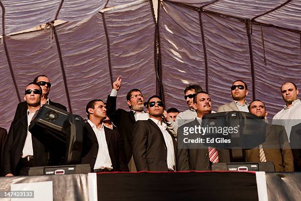 Egyptian President-elect Mohamed Morsi speaks on stage in Tahrir Square on June 29 in Cairo, Egypt. Accompanied by Egypt's 'Presidential Guard',...