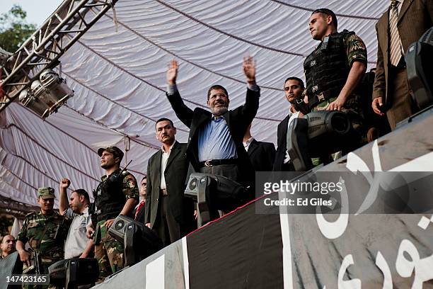 Egyptian President-elect Mohamed Morsi speaks on stage in Tahrir Square on June 29 in Cairo, Egypt. Accompanied by Egypt's 'Presidential Guard',...