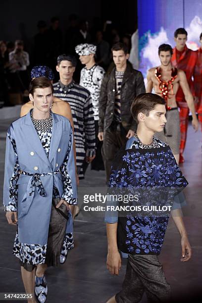Models display creations by British fashion designer Bill Gaytten for the label John Galliano fashion house during the men's spring-summer 2013...
