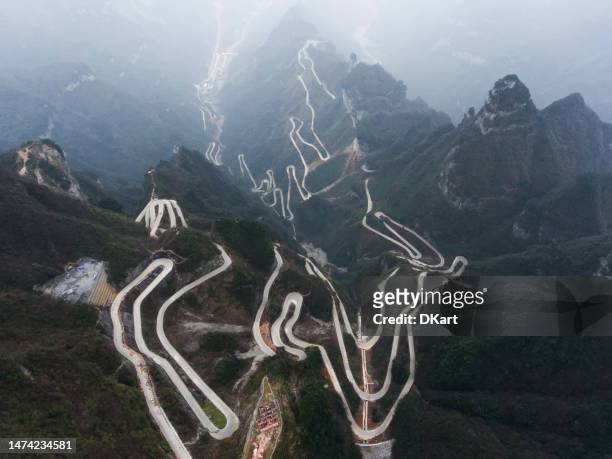 view of winding road of tianmen mountain national park in china - zhangjiajie national forest park stock pictures, royalty-free photos & images