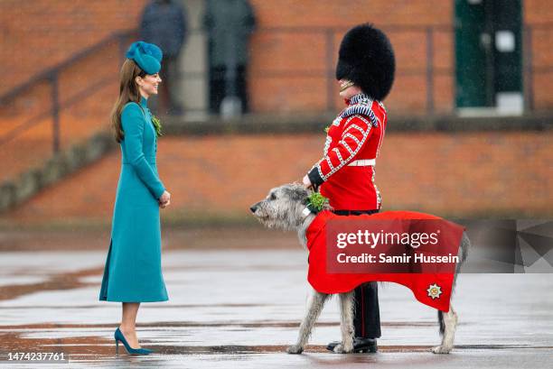Catherine, Princess of Wales presents Irish Wolf Hound 'Turlough Mor' , regimental mascot of the Irish Guards, with a sprig of shamrock during the...