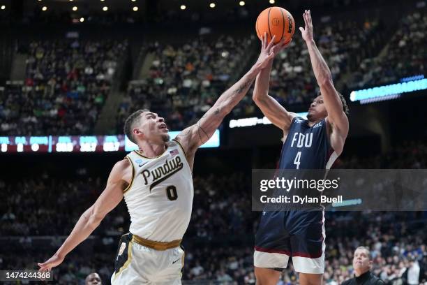 Grant Singleton of the Fairleigh Dickinson Knights shoots over Mason Gillis of the Purdue Boilermakers during the second half in the first round of...