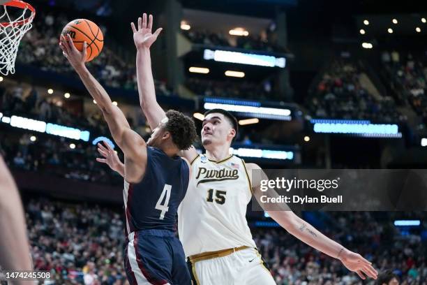 Zach Edey of the Purdue Boilermakers defends a shot from Grant Singleton of the Fairleigh Dickinson Knights during the second half in the first round...