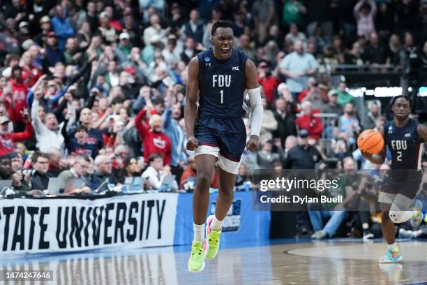 Joe Munden Jr. #1 of the Fairleigh Dickinson Knights celebrates after beating the Purdue Boilermakers 63-58 in the first round of the NCAA Men's...