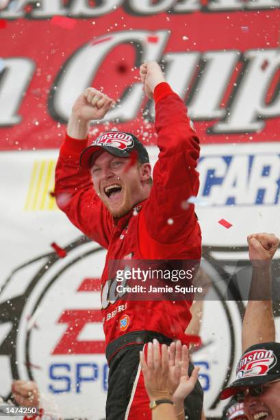 Dale Earnhardt, Jr. Driver of the Budweiser Chevrolet Monte Carlo, celebrates in victory lane after winning the NASCAR Winston Cup EA Sports 500 at...