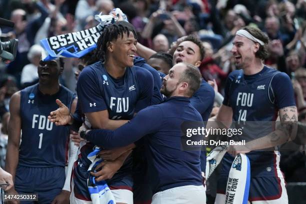 Sean Moore of the Fairleigh Dickinson Knights celebrates with the team after beating the Purdue Boilermakers 63-58 in the first round of the NCAA...