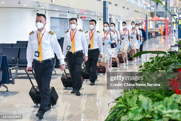 Flight crew prepare to board a plane at Haikou Meilan International Airport on March 17, 2023 in Haikou, Hainan Province of China. Haikou resumed its...