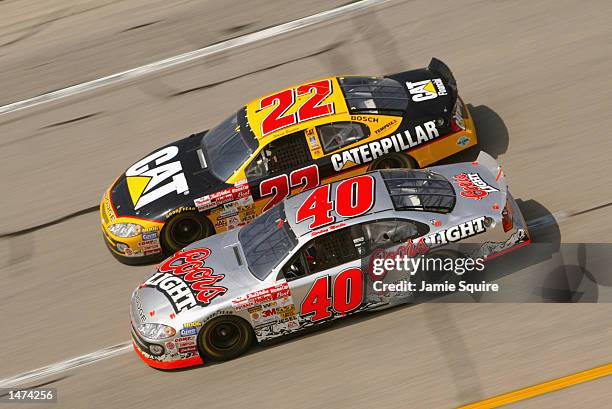 Jamie McMurray, driver of the Ganassi Racing Dodge Intrepid R/T, races alongside Ward Burton, driver of the Bill Davis Racing Dodge Intrepid R/T,...