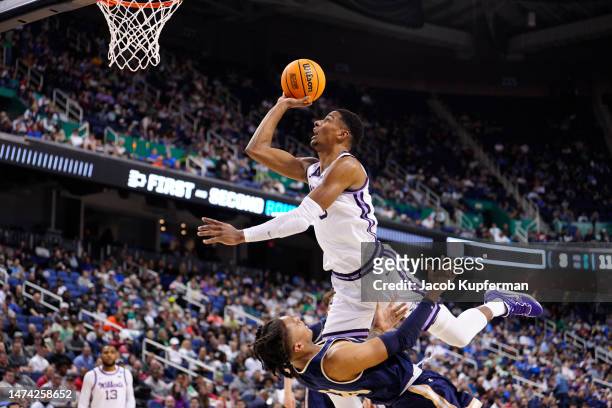 David N'Guessan of the Kansas State Wildcats drives to the basket against RaeQuan Battle of the Montana State Bobcats during the first half in the...