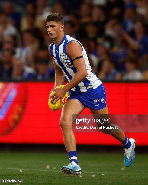 Harry Sheezel of the Kangaroos looks to pass the ball during the round one AFL match between North Melbourne Kangaroos and West Coast Eagles at...