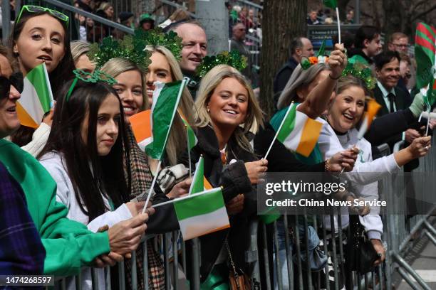 Spectators watch and cheer during the St. Patrick's Day Parade along 5th Avenue on March 17, 2023 in New York City.