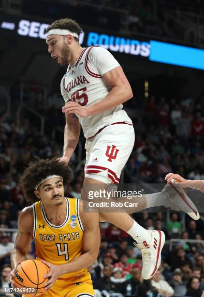 Race Thompson of the Indiana Hoosiers jumps while defending Chris Payton of the Kent State Golden Flashes in the second half during the first round...