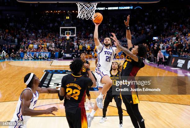 JaKobe Coles of the TCU Horned Frogs makes the game winning basket over Warren Washington and Desmond Cambridge Jr. #4 of the Arizona State Sun...